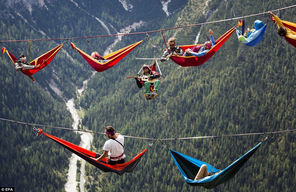 Highliners sleep in hammocks suspended over Italian Alps