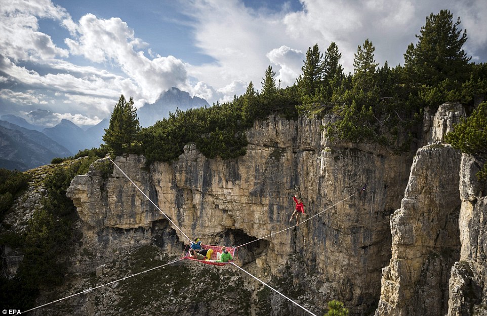 Highliners sleep in hammocks suspended over Italian Alps