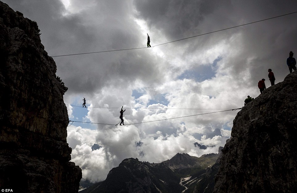 Highliners sleep in hammocks suspended over Italian Alps