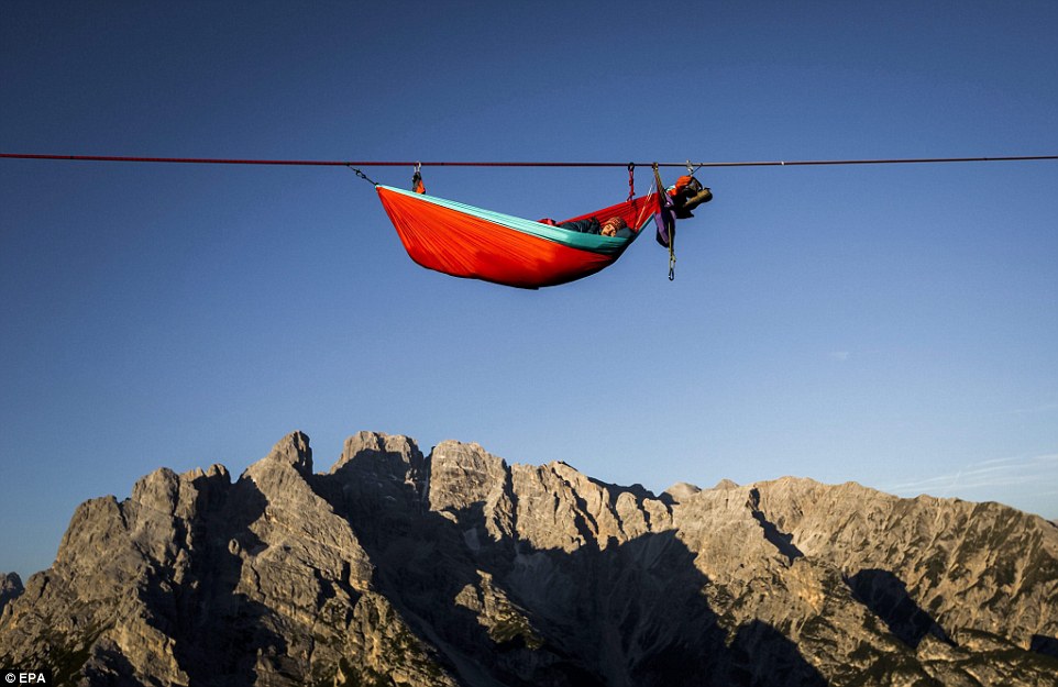 Highliners sleep in hammocks suspended over Italian Alps