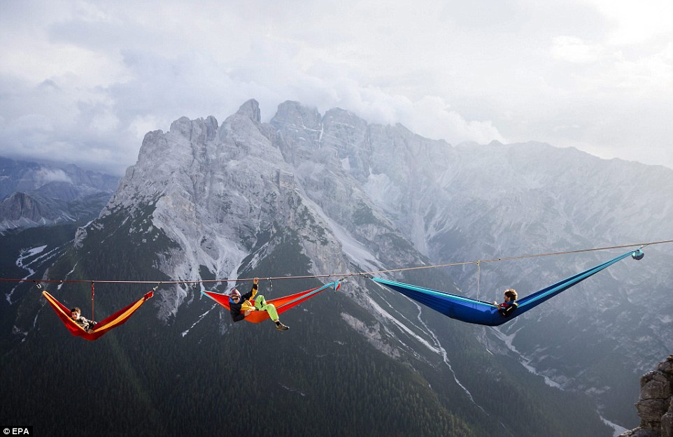 Highliners sleep in hammocks suspended over Italian Alps