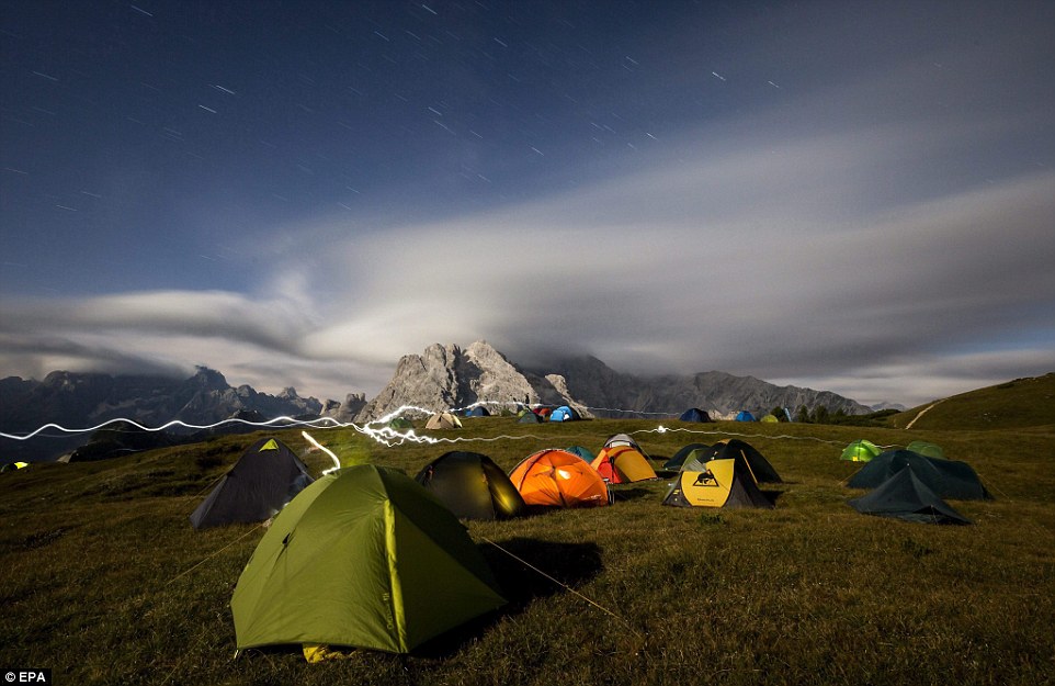 Highliners sleep in hammocks suspended over Italian Alps