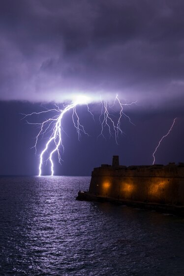 A lightning bolt strikes the sea near Fort St Elmo in Valletta, Malta